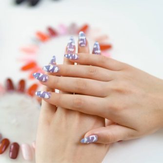 beautiful manicure on color palette background e1643346460858