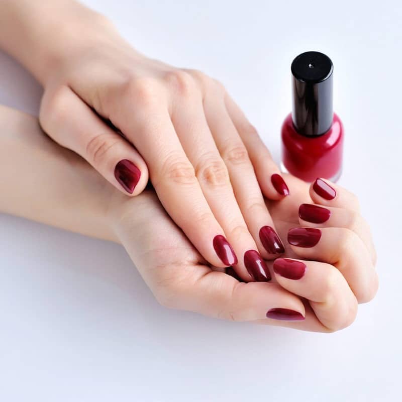 hands of a woman with dark red manicure and nail p 2021 08 26 18 28 16 utc e1643346806313