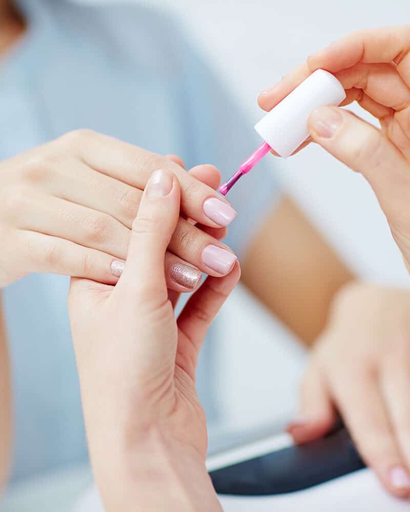 a person painting a nail